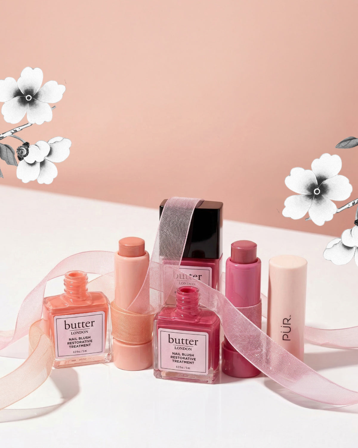 Butter LONDON x PUR Minerals Blush Crush display with pink peach nail polishes and matching blush against a peach backdrop