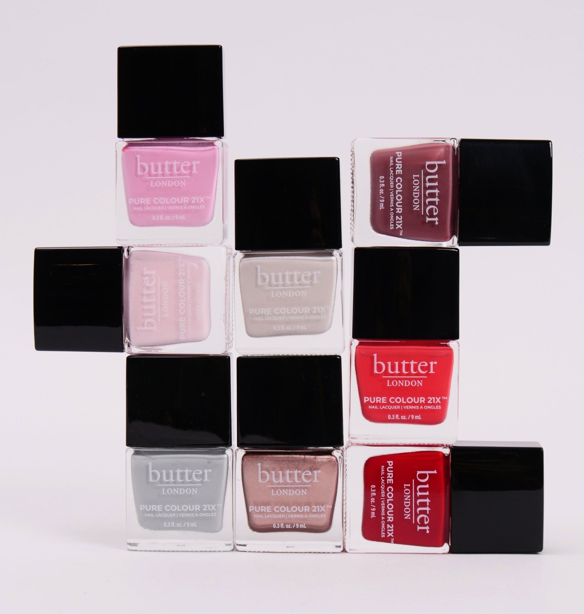 Butter London nail polish bottles in pink and nude shades arranged in a grid on a light background