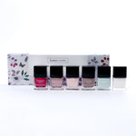 Holiday Sparkles 6-Piece PC21X set box with floral design and a row of black capped nail polish bottles in front.