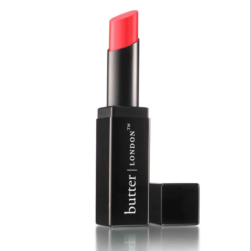 Bright pink lipstick extended from a black rectangular case with butter LONDON branding and cap removed.