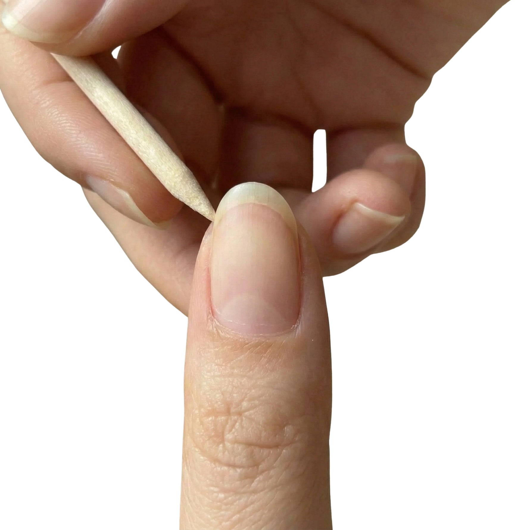 Wooden dual sided cuticle pusher held between fingers near the nail showing beveled edge and pointed tip