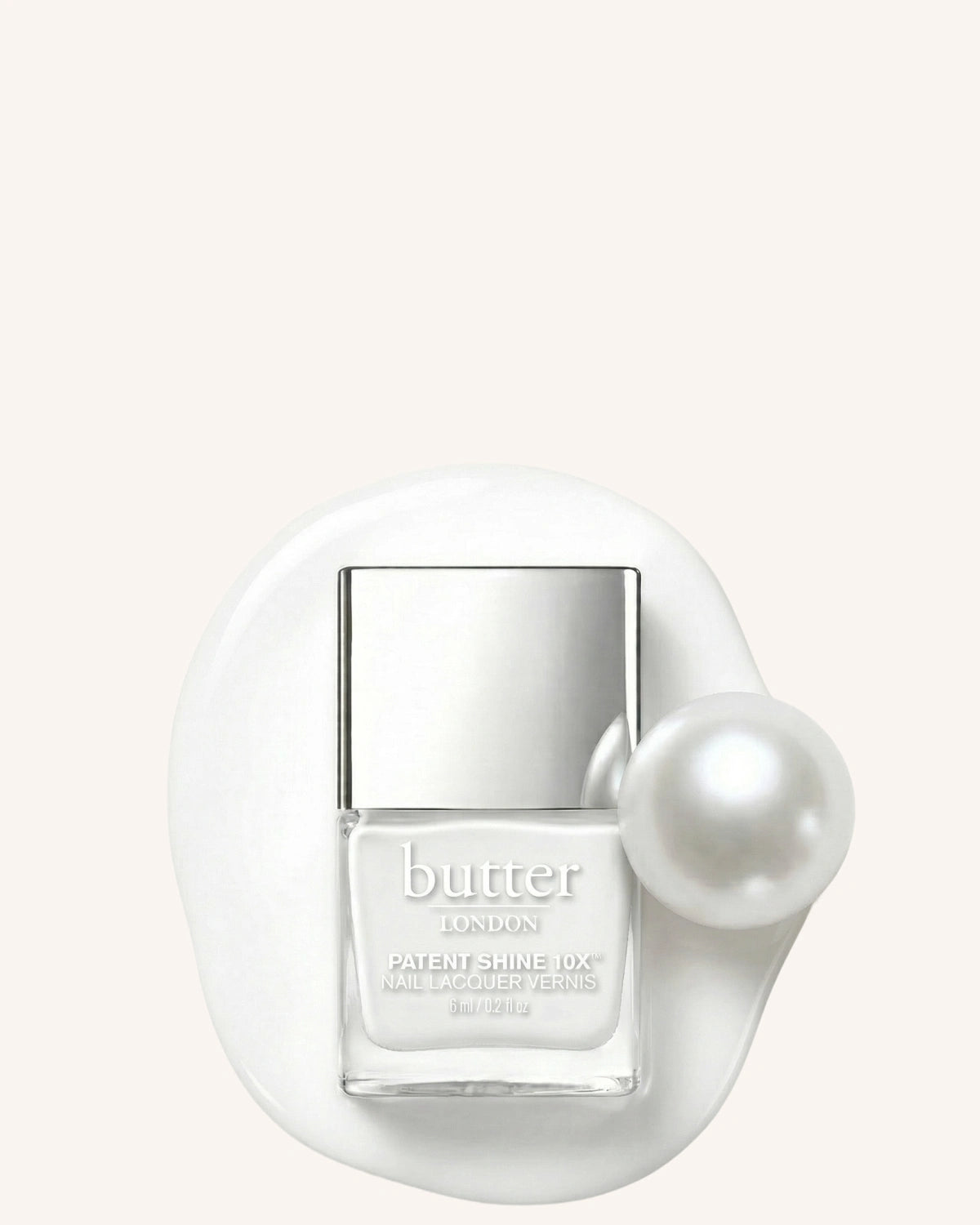 June Colour of the Month - Free mini PS10X in Cotton Buds on $50+: White nail polish bottle next to pearl laying in swatch against cream background (mobile - focal point)
