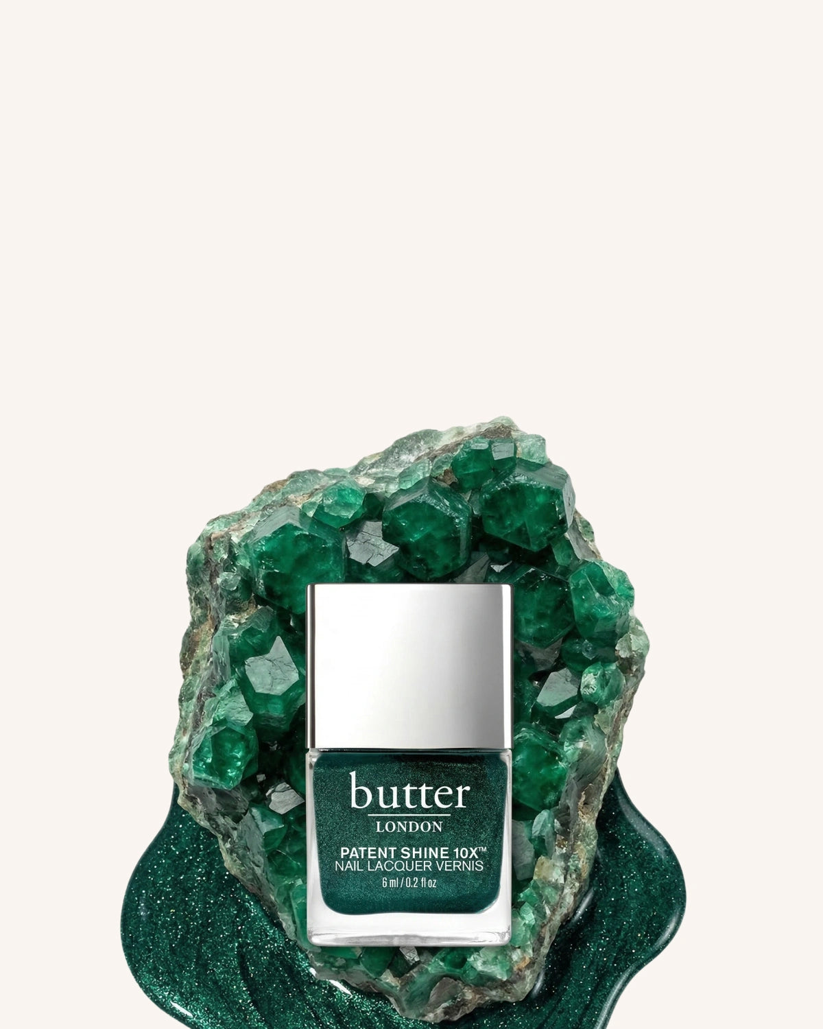 May Colour of the Month - Free mini Royal Emerald with orders $50+: butter LONDON PS10X in shade Royal Emerald sitting against emerald stone (mobile - focal point)
