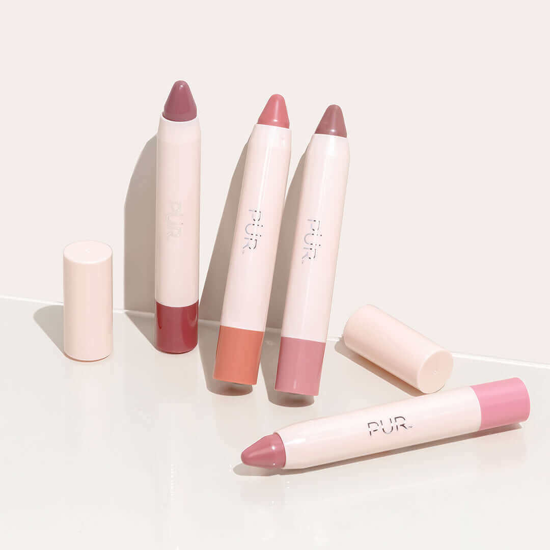 Four pastel pink Silky Pout Creamy Lip Chubby lip balms arranged on a pale surface
