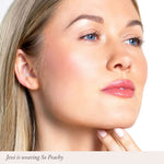 Close-up of a woman with soft pink lips wearing So Peachy lip color.
